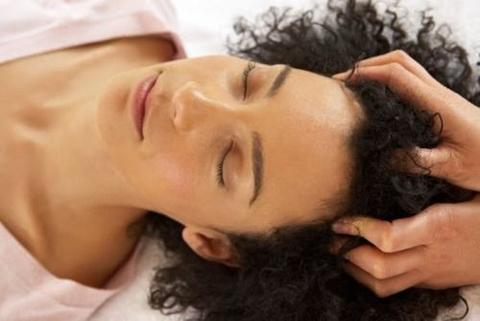 Show your natural hair love by handling it gently. Lady receiving head massage.